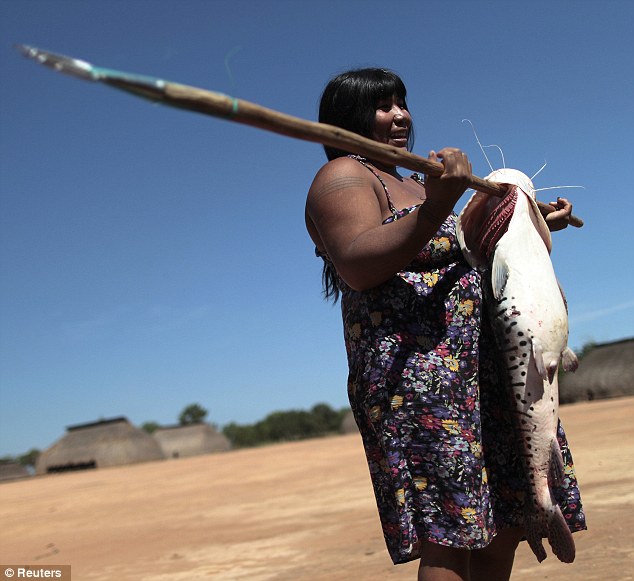 Time for dinner: A woman holds a large fish that the tribesmen caught in the Tuatuari River