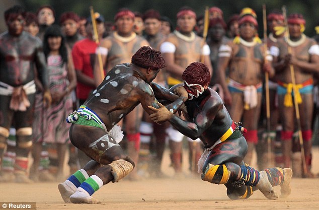 Spectacular: The wrestlers decorated their bodies with brightly coloured markings before going into battle