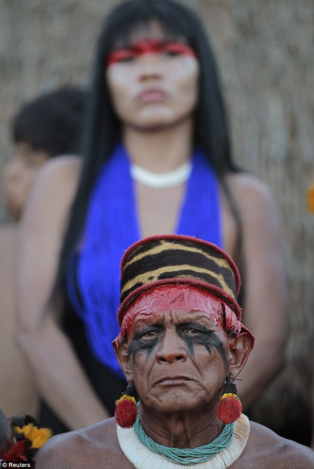 Respectful: A man and woman from the Yawalapiti tribe take a moment to reflect as they honour a former great leader